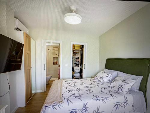 a bedroom with a bed with a green headboard at Malaga entire rental unit in Málaga