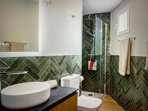 a bathroom with a toilet and a sink and a shower at Malaga entire rental unit in Málaga