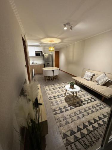 a living room with a couch and a table at Frente a Playa Brava, Cerca Cavancha, WiFi in Iquique