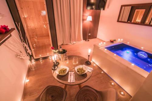 a small table in front of a swimming pool at Alma Suites - Il Nido d'Amore in Livorno