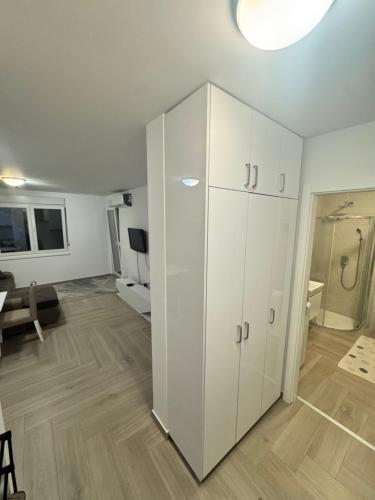 a large white cabinet in a living room at Montê Apartment in Beograd