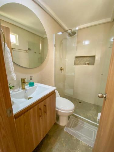 a bathroom with a sink and a toilet and a mirror at Apartamento Sabaii 201 in Cartagena de Indias