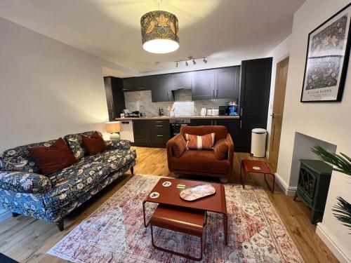 a living room with a couch and a chair at Old Betting Shop for 3 & Furry Friend in Hayfield