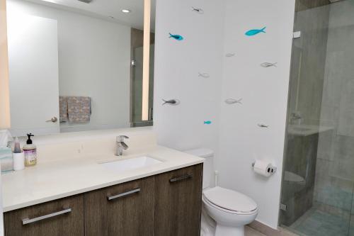 a bathroom with a sink and a toilet and a shower at Downtown Miami Slice of Paradise in Miami
