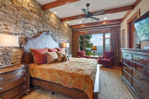 a bedroom with a bed and a stone wall at Sweet Autumn at Blue Ridge Mountain Club in Stony Fork