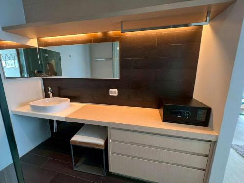 a bathroom counter with a sink and a mirror at Stay with me by Veranda Resident in Na Jomtien