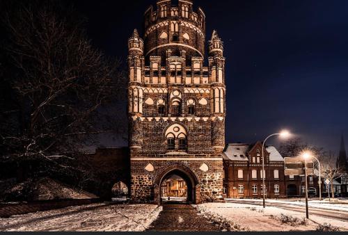 ein großes Gebäude mit einem Glockenturm bei Nacht in der Unterkunft Gnaden -und Ferienhof Saale Wittgenstein in Schorstedt