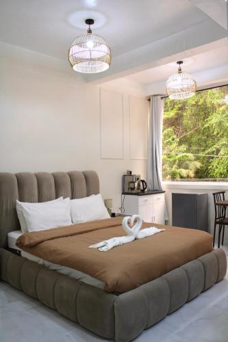 a bedroom with a large bed with a towel on it at Mayad Boutique Hotel El Nido - Newly Renovated in El Nido