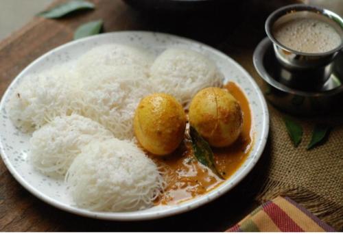 a plate of food with rice on a table at Silver home stay vagamon in Vagamon
