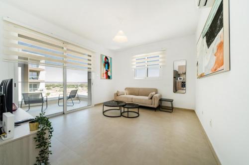 a living room with a couch and a table at 1 bedroom flat next to university in Aglantzia