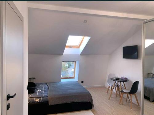 a bedroom with a bed and a window and a table at Lux Apartments in Truskavets