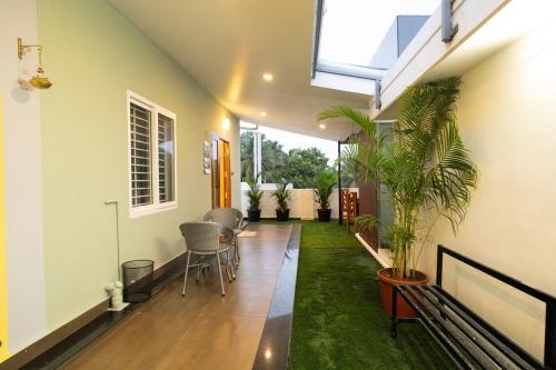 a hallway of a house with a plant at Green Home Stay - 10 Mins Walk to Kanyakumari Main Beach in Kanyakumari