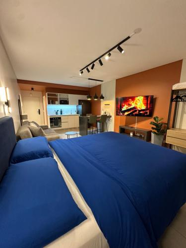 a large blue bed in a living room at Foster Studio - Park 3 in Buenos Aires