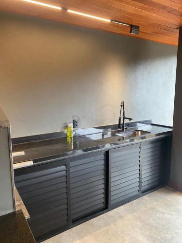 a kitchen with a sink and a counter at Suíte Itaipava in Araras Petropolis