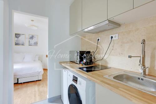 a kitchen with a sink and a washing machine at New, Elegant & Cozy, 2 Guests in Bagneux