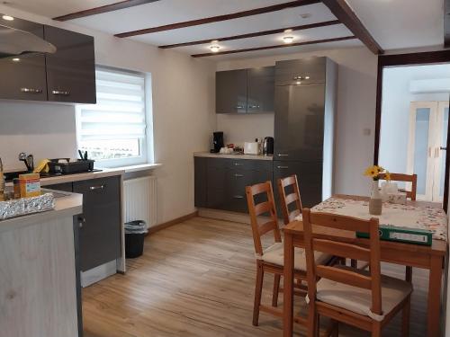 a kitchen and dining room with a table and chairs at Waldblick in Hirschhorn in Hirschhorn
