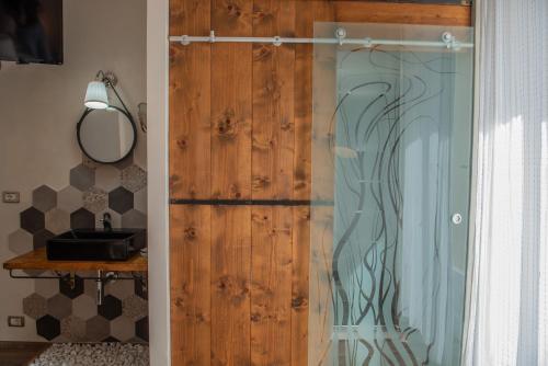 a sliding glass door in a room with a mirror at Fra Diavolo in Diano Marina