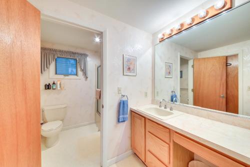 a bathroom with a sink and a toilet and a mirror at Charming Retreat with Deck about 4 Mi From Casco Bay! in Orrs Island