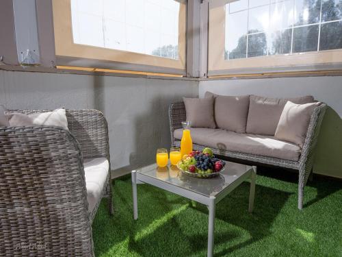 a living room with a couch and a table with fruit at Siesta in Achziv in Nahariyya