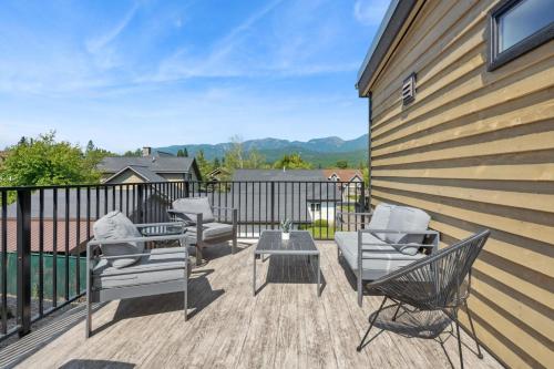 a patio with chairs and a table and a fence at Quarry A28 in Whitefish