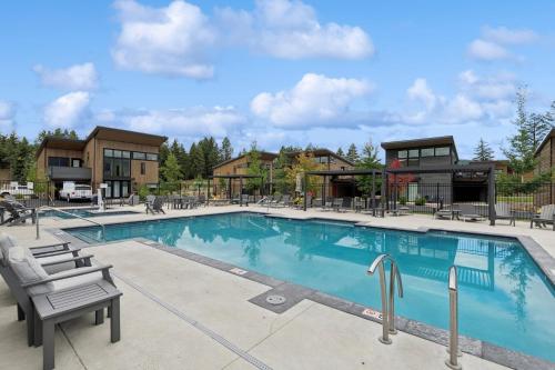 a large swimming pool with chairs and buildings at Quarry A28 in Whitefish
