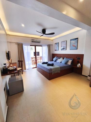 a bedroom with a bed and a ceiling fan at Makadal'Eau Boutique Resort in Siquijor