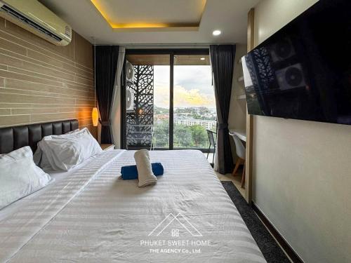 a bedroom with a bed with a towel on it at Condo sea view rawai beach by phuket sweet home in Rawai Beach