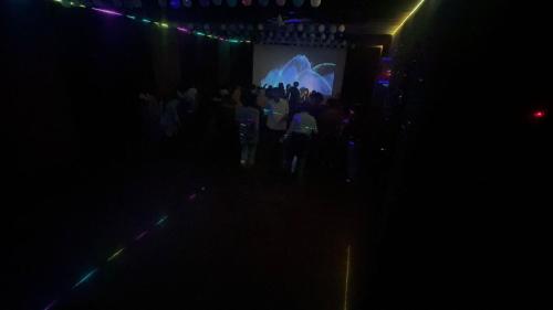 a group of people standing in front of a screen at Safayar holidays Ramakkalmedu in Ramakkalmedu