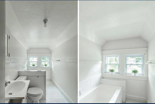 a white bathroom with a tub sink and a toilet at charming apartment at Lynchburg in Lynchburg