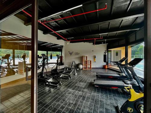 a gym with treadmills and exercise bikes in it at Suites - Llanogrande in Rionegro