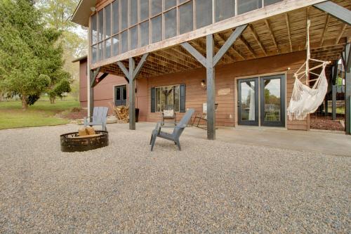 a patio with two chairs and a fire pit in front of a building at Waterfront Home Near Mark Twain National Forest in Poplar Bluff