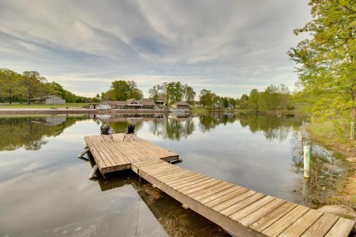 a dock in the middle of a lake at Waterfront Home Near Mark Twain National Forest in Poplar Bluff