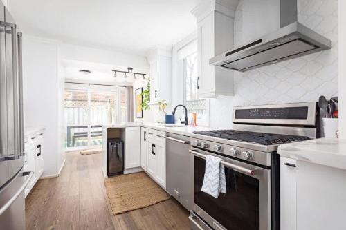 een keuken met een roestvrijstalen fornuis bovenste oven bij Charming 3 Beds Ossington Home in Toronto