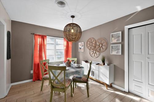 a dining room with a table and chairs and a window at Happy Days at Two Oaks 4BD Home Minutes From Beautiful Lake Hollingsworth in Lakeland