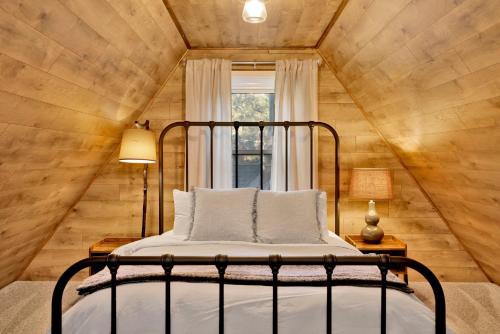 a bed in a room with a wooden wall at The Summit at Sherwood #618 in Big Bear City