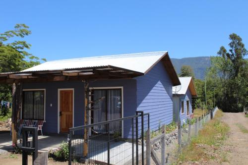 a blue tiny house with a metal roof at Cabañas Dos Laureles in Coñaripe