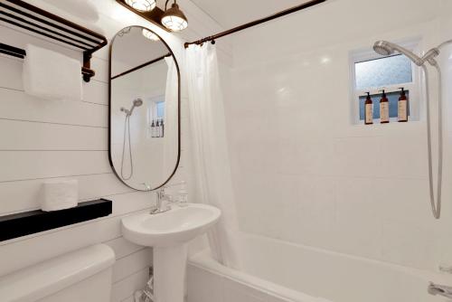 a white bathroom with a sink and a mirror at The Summit at Sherwood #618 in Big Bear City