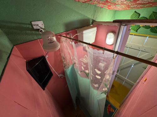an overhead view of a pink room with a lamp at Tia Chica Camburi in Camburi