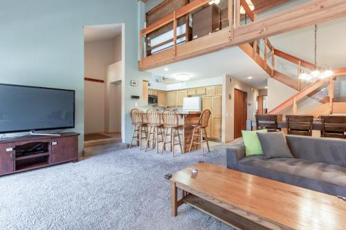 a living room with a couch and a tv at Snowcreek IV 588 in Mammoth Lakes
