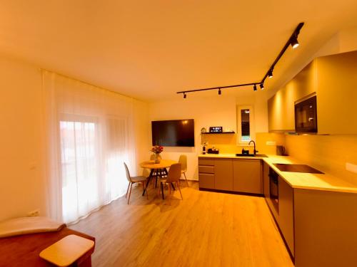 a kitchen with a table and a dining room at DiViNI apartment in Zadar