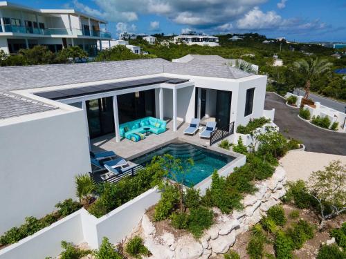 an aerial view of a house with a swimming pool at Skyline Villas - Villa Luna Oceanfront with Private Pool in Providenciales