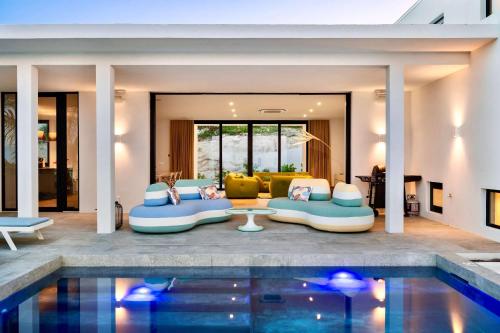 a villa with a swimming pool and a living room at Villa Jupiter with Private Pool Oceanfront in Turtle Cove