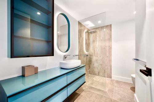 a bathroom with a sink and a mirror at Villa Venus with Private Pool Oceanfront in Turtle Cove