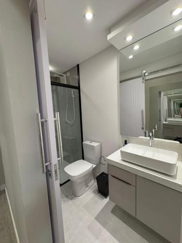 a white bathroom with a toilet and a sink at Apartment 403 withoeft in Pomerode