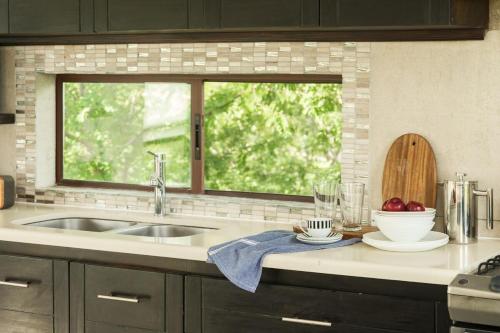 a kitchen counter with a sink and a window at Vista Popoyo 3BR Coastal Retreat with Surf & Mangrove Views in Popoyo