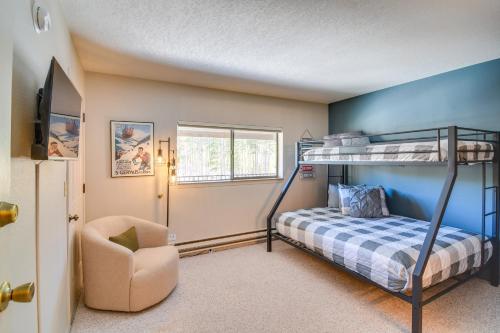 a bedroom with a bunk bed and a chair at Cozy Winter Park Condo Bike, Ski, and Hike! in Winter Park