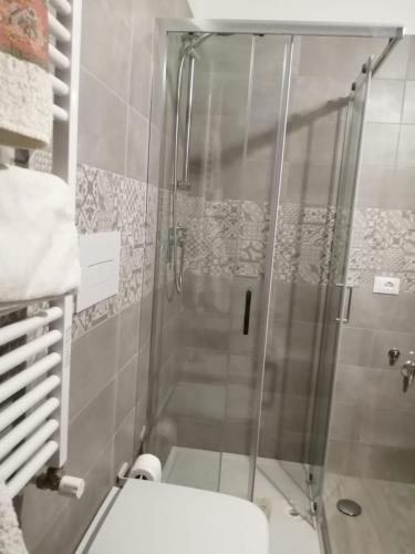 a shower with a glass door in a bathroom at Suite Petit in Vairano Scalo