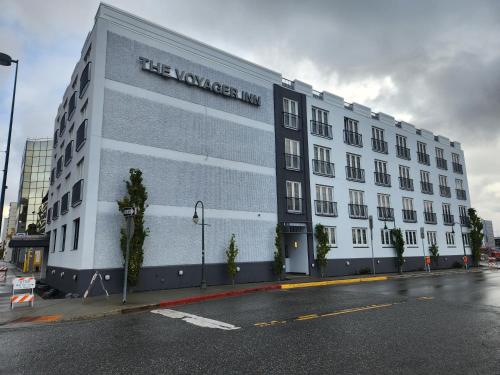 a white building with a sign on the side of it at The Voyager Inn in Anchorage