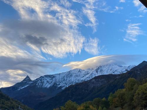a view of a snow covered mountain under a cloudy sky at Chalet Perle des Alpes in Peisey-Nancroix