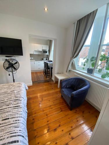 a living room with a couch and a table at Heart of Notts, Modern Studio, Great City Views in Nottingham